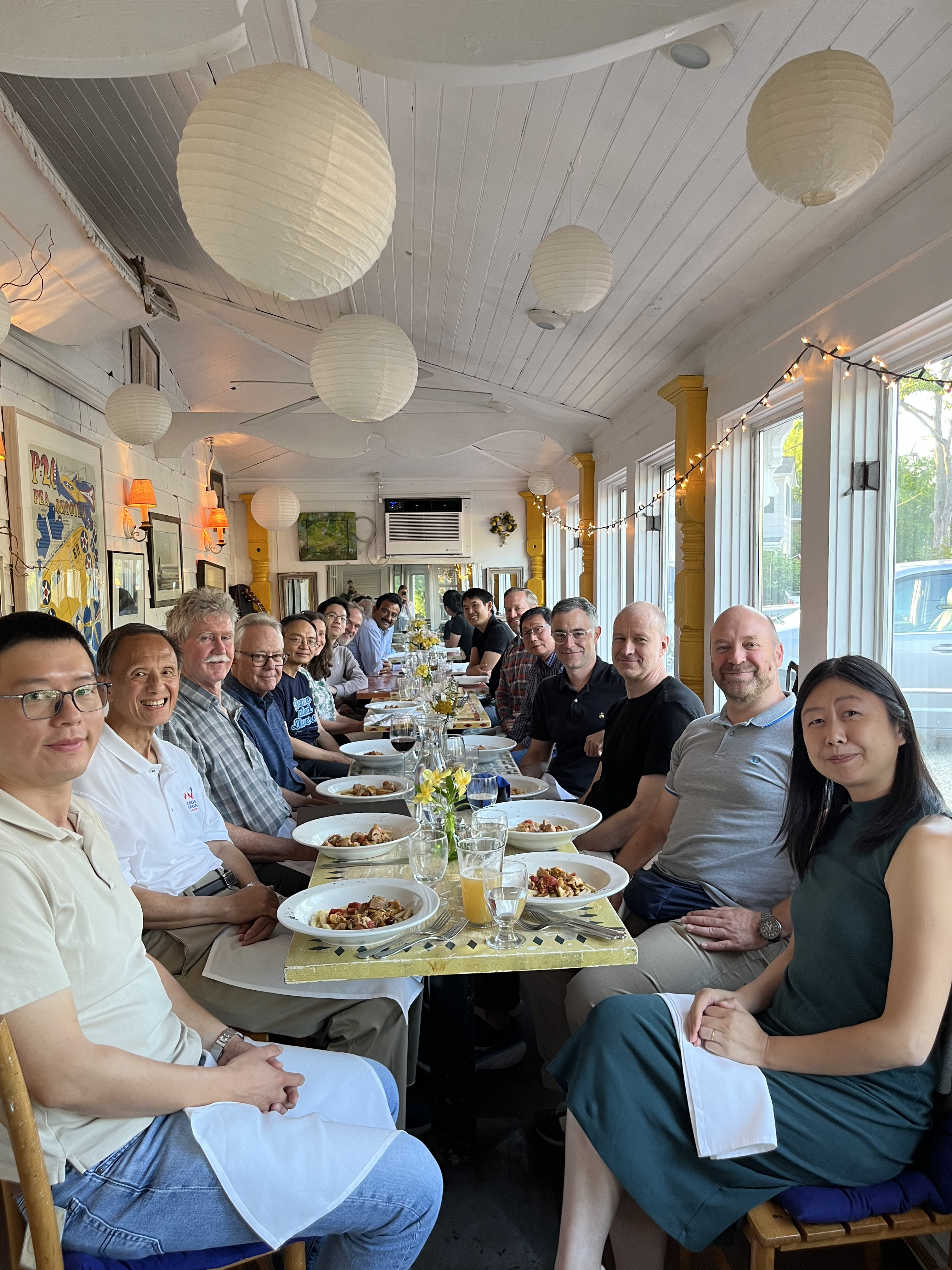 Friends and colleagues gathered around a long table at Ian Robinson's retirement dinner