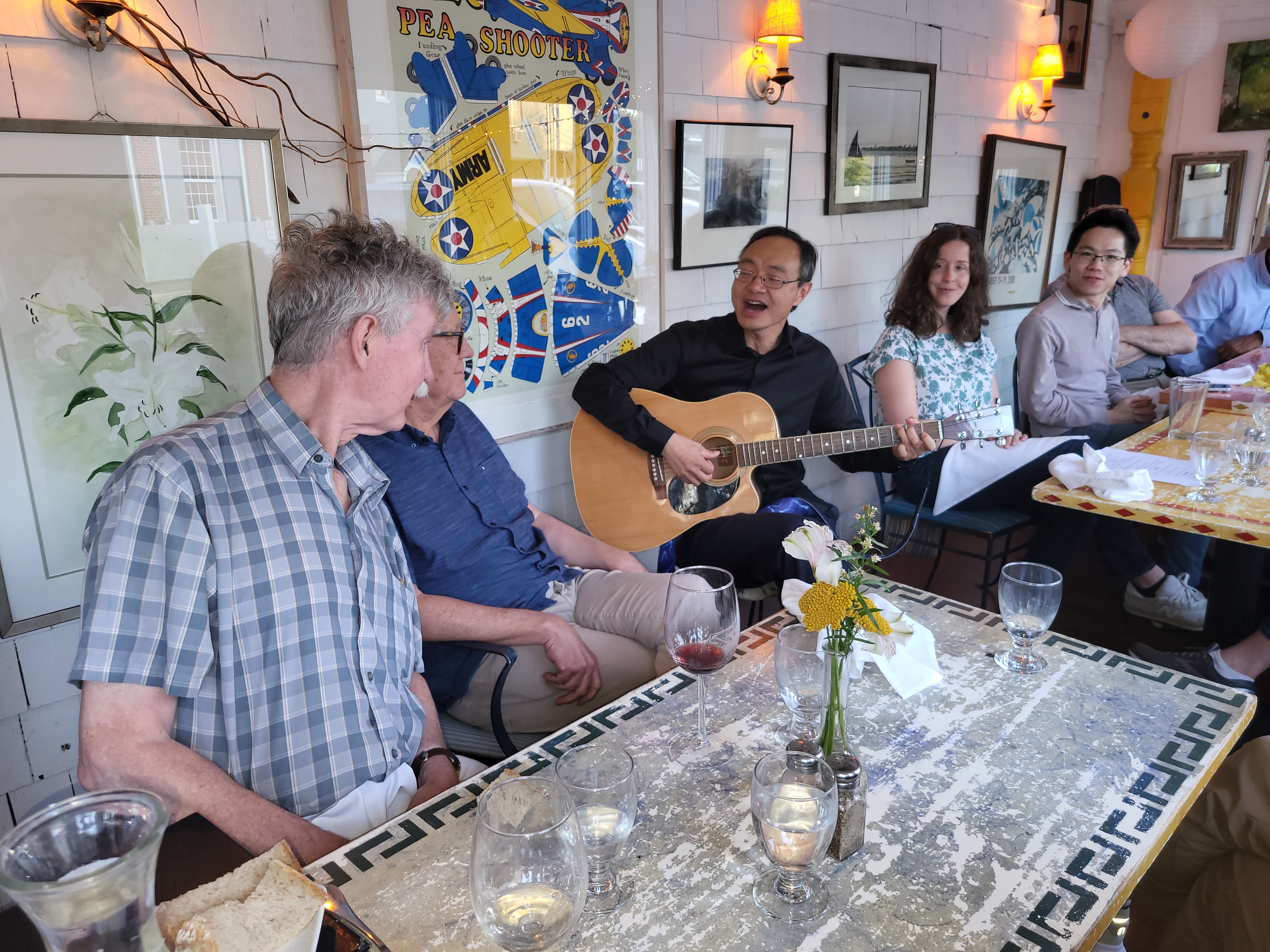 Weiguo Yin playing guitar for Ian Robinson and the guests at the retirement dinner