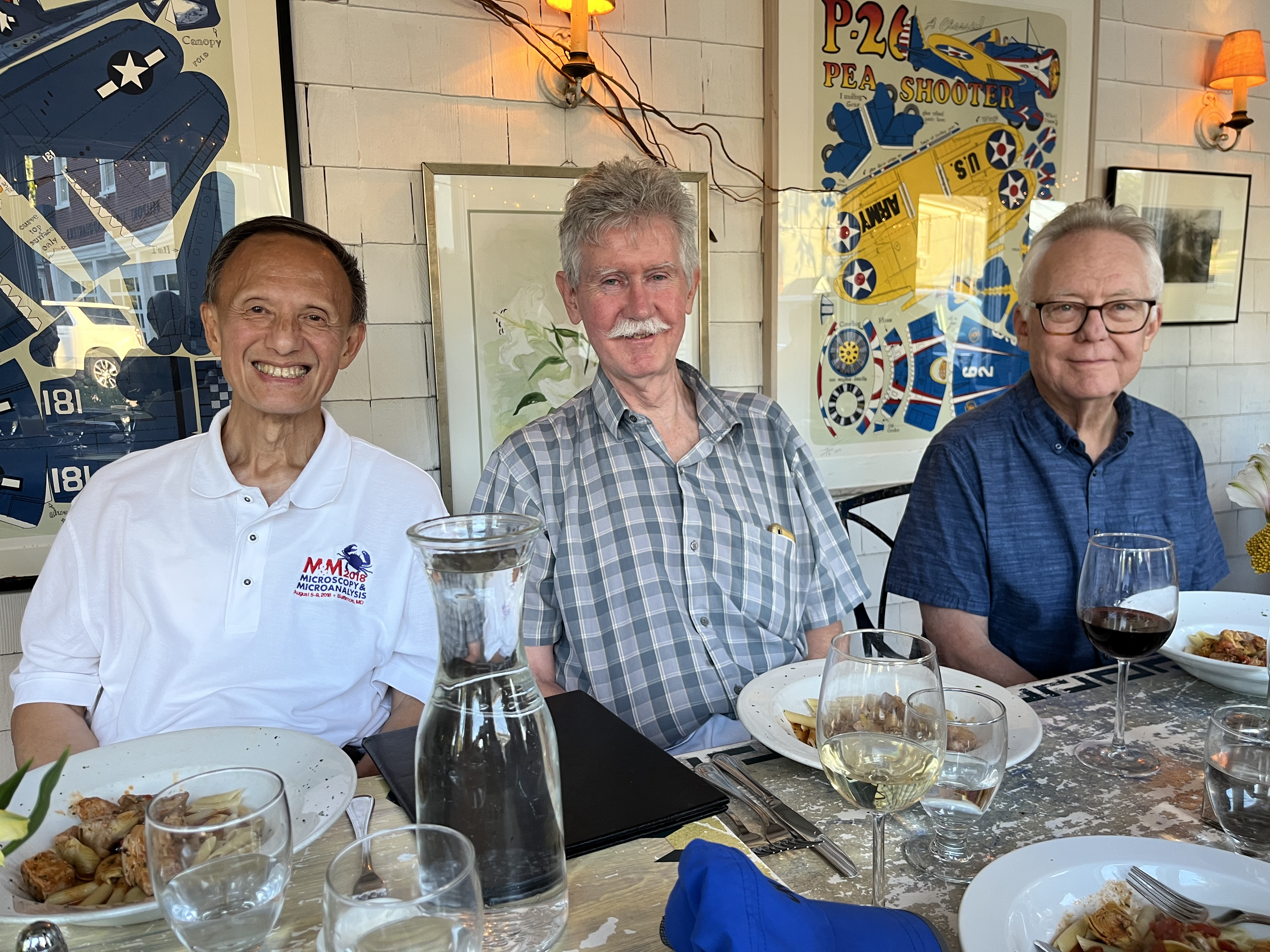 Yimei Zhu, Ian Robinson, and Doon Gibbs seated together at the retirement dinner